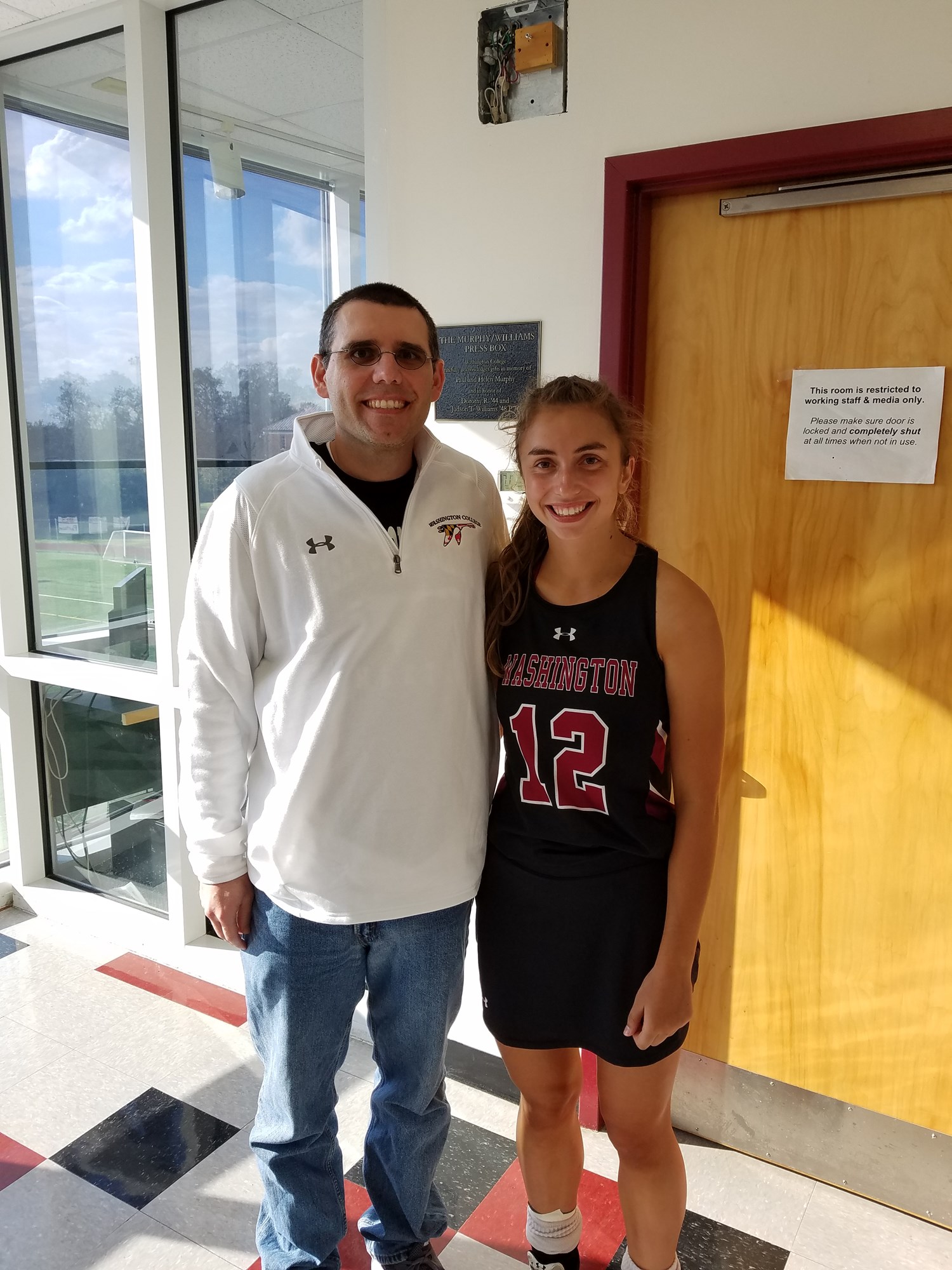 Jason Bryden with athletic communications student worker Sabrina Jenkins '19 after her senior day field hockey game in October 2018. Jenkins worked in the office from February 2017-May 2019.